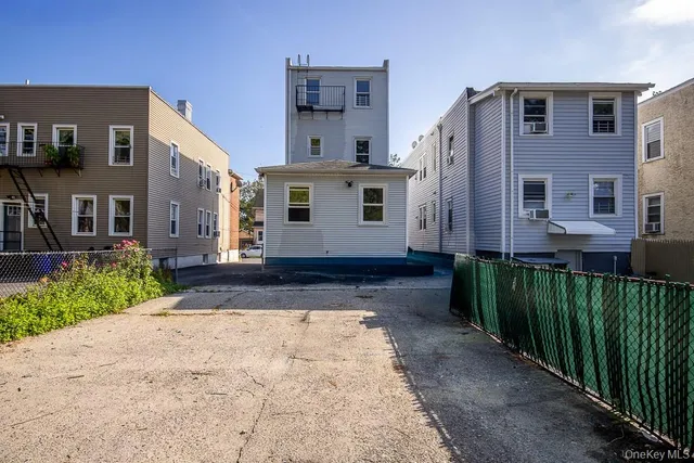 a view of a house with a yard and garage