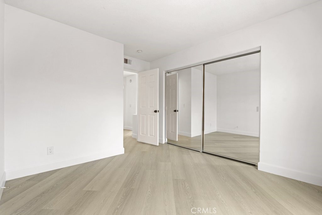 4 Las Cruces Irvine, CA 92614 - Photo 18 of 33 an empty room with wooden floor and sliding door