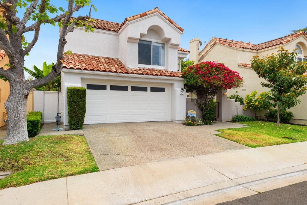 4 Las Cruces Irvine, CA 92614 - Photo 2 of 33 a front view of a house with a yard and garage
