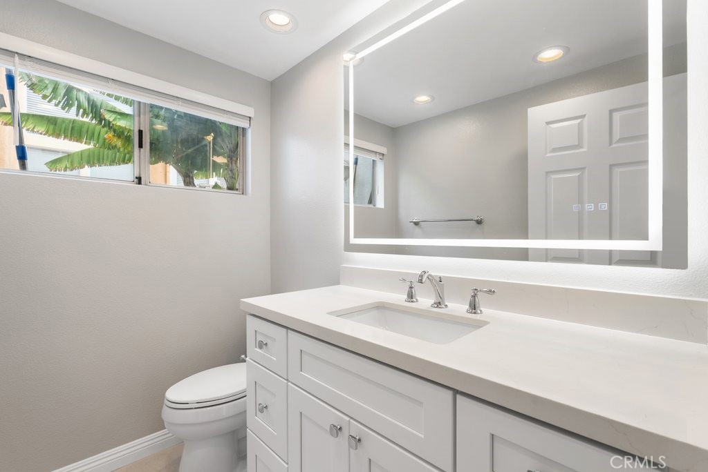 4 Las Cruces Irvine, CA 92614 - Photo 21 of 33 a bathroom with a sink a toilet a mirror and a window