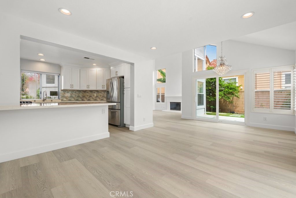 4 Las Cruces Irvine, CA 92614 - Photo 10 of 33 a view of kitchen with stainless steel appliances granite countertop a stove a sink dishwasher and a refrigerator with wooden floor