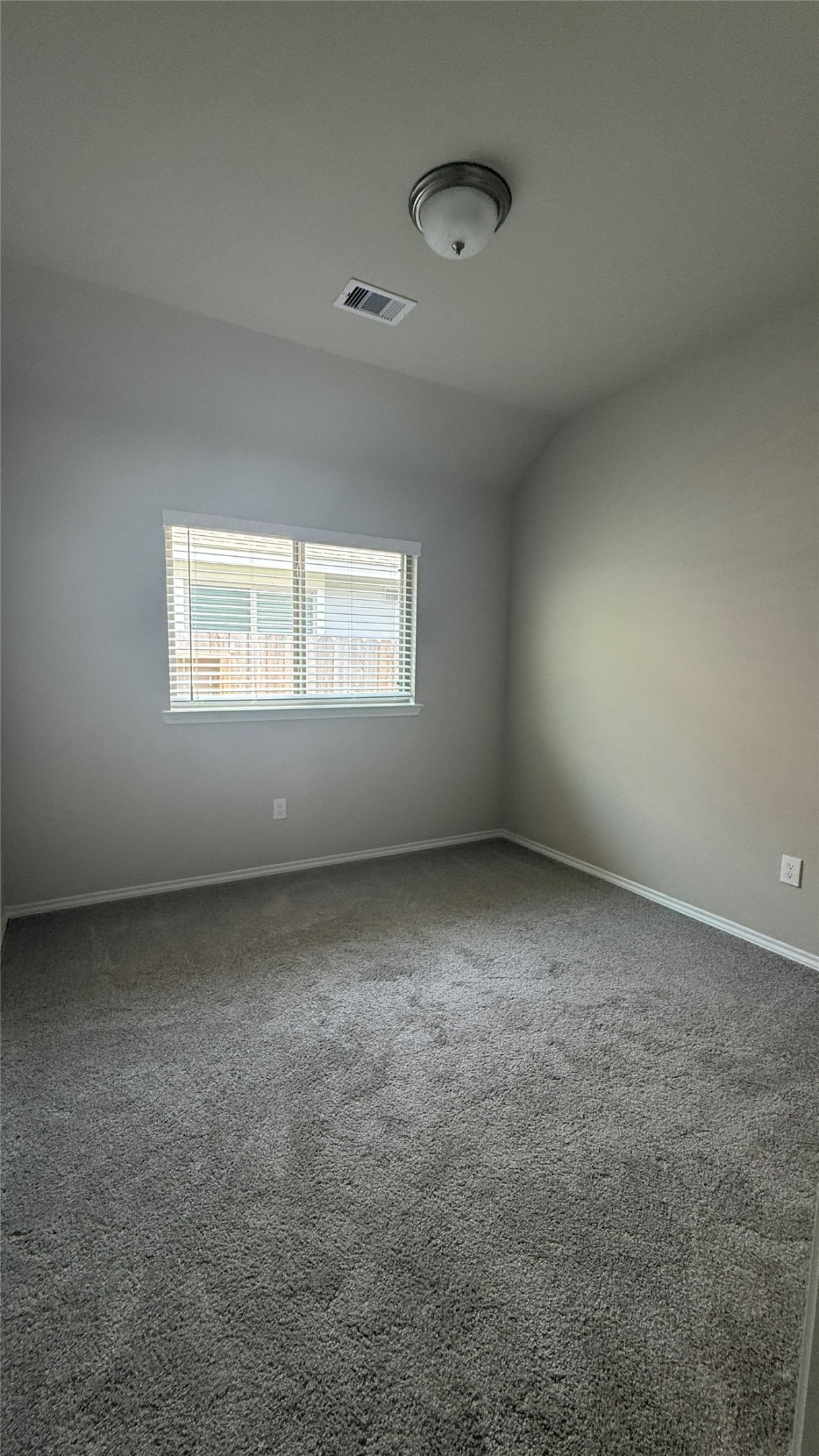 31961 Retama Rnch Drive Spring, TX 77386 - Photo 8 of 25 This is a cozy, carpeted room with neutral walls and a ceiling light fixture. A window provides natural light, and there's a vent on the ceiling, ideal for a bedroom or office space.