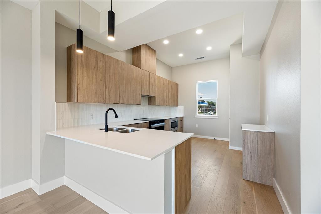 4060 Spring Valley Road, Unit 405 Farmers Branch, TX 75244 - Photo 4 of 10 Beautiful Kitchen with Flat Cooktop, Custom Vent hood, Coffee Station, and Samsung Appliances include stove, microwave drawer, oven and dishwasher,