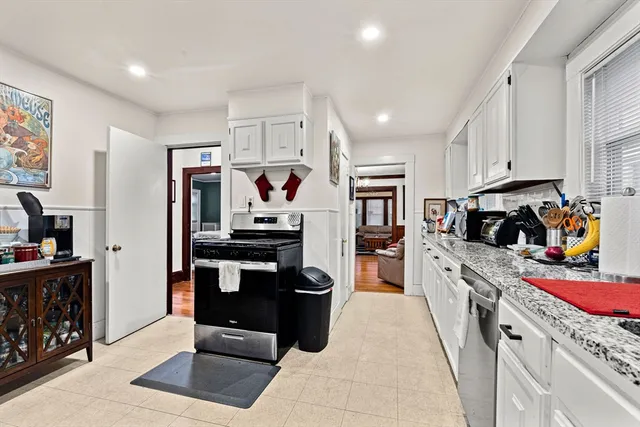 a kitchen with stainless steel appliances granite countertop a refrigerator stove and sink
