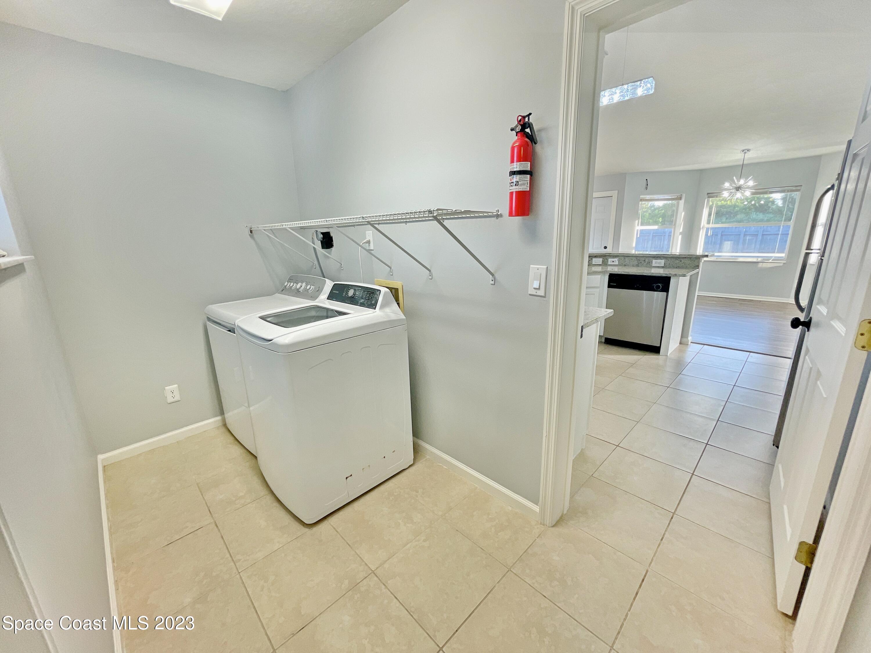 880 Kimberly Road Palm Bay, FL 32908 - Photo 13 of 18 a view of a hallway with washer and dryer