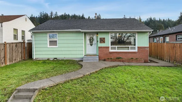 a front view of a house with a yard and outdoor seating