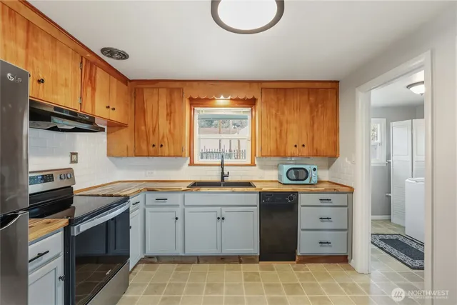 a kitchen with a sink stove and cabinets