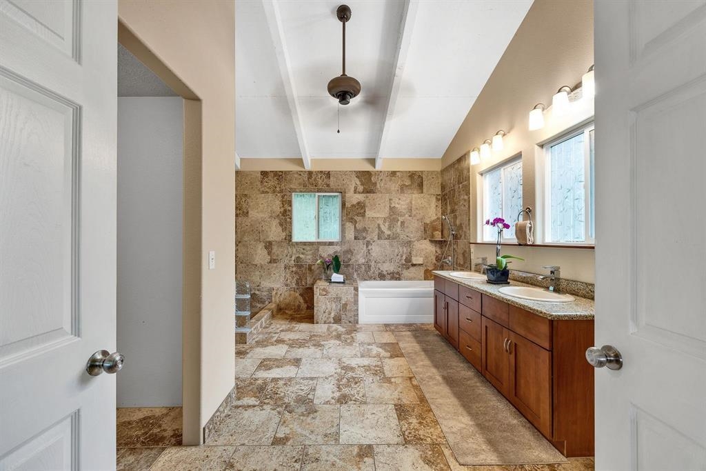 143 Alalele Place Hana, HI 96713 - Photo 16 of 50 a large bathroom with a double vanity sink a mirror and a bathtub