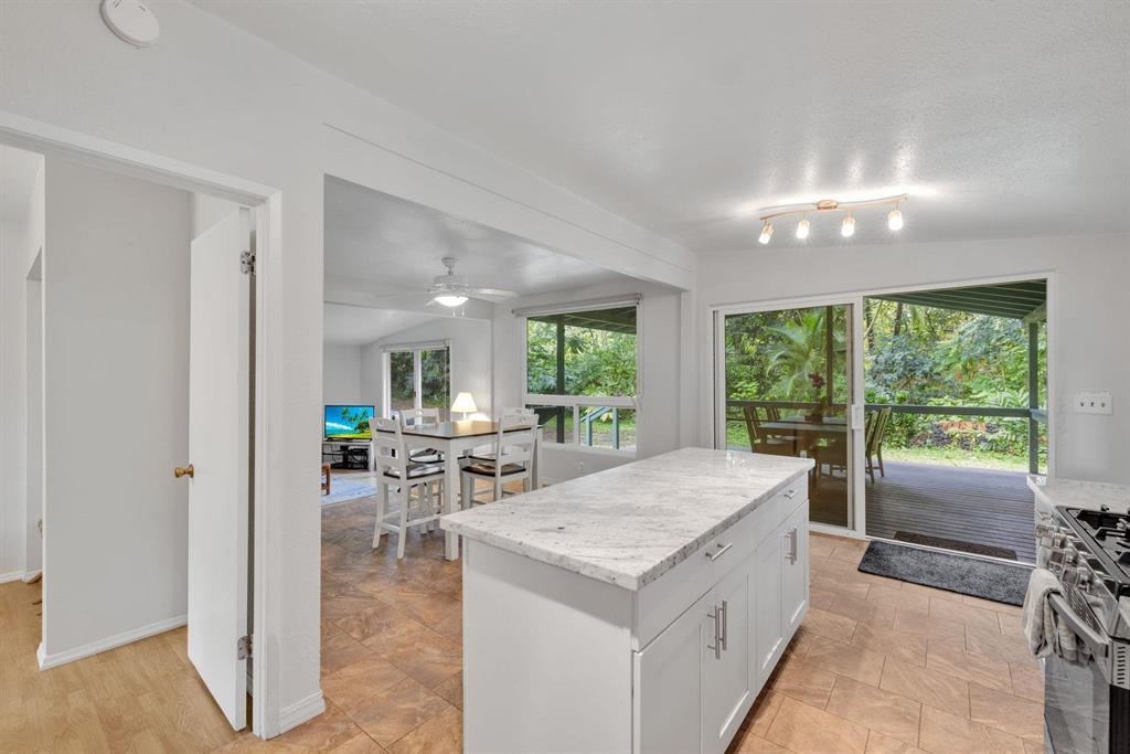 143 Alalele Place Hana, HI 96713 - Photo 33 of 50 a kitchen with a stove a refrigerator and a view of living room
