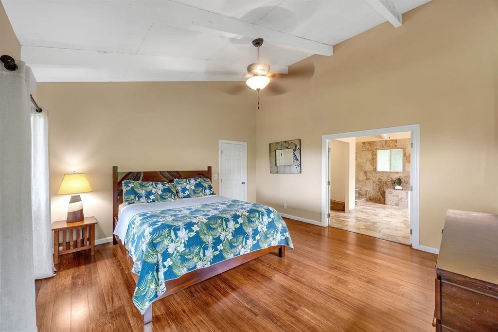 143 Alalele Place Hana, HI 96713 - Photo 40 of 50 a bedroom with a bed and wooden floor