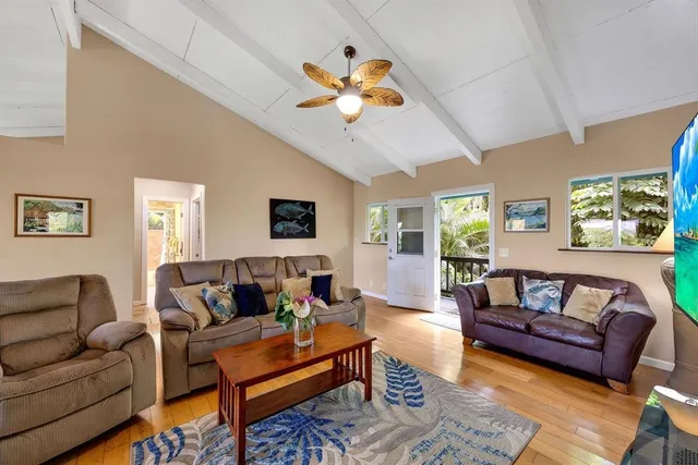 a living room with furniture and a ceiling fan