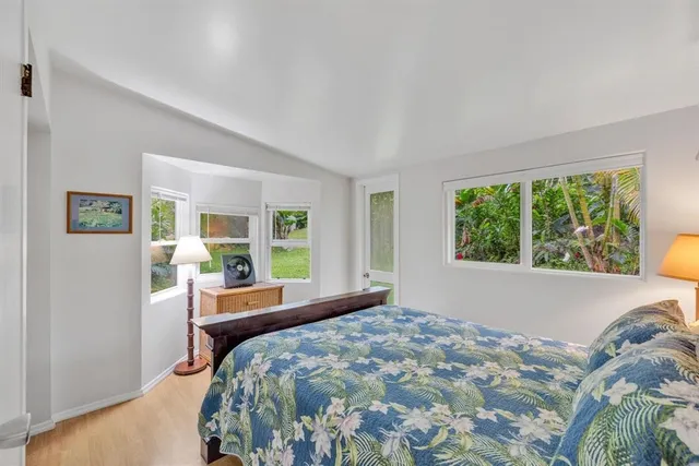 a bedroom with two beds and a large window