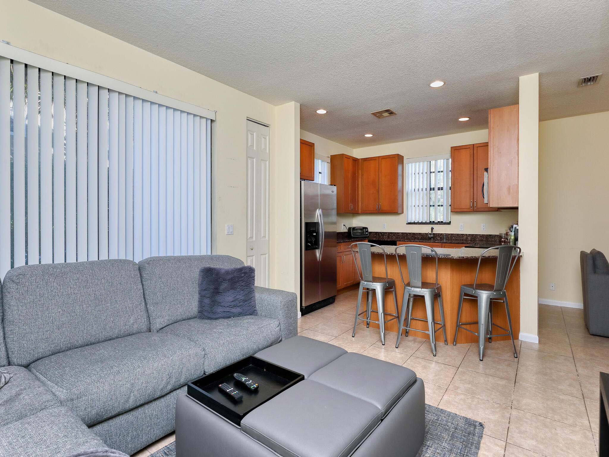 102 Astor Circle Delray Beach, FL 33484 - Photo 11 of 29 a living room with furniture and kitchen view