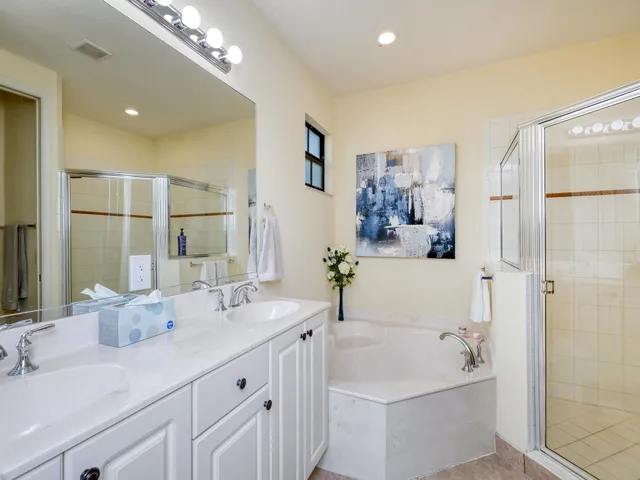 a bathroom with a tub sink and mirror