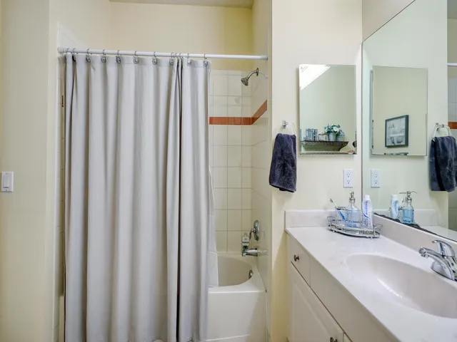 a bathroom with a double vanity sink and mirror