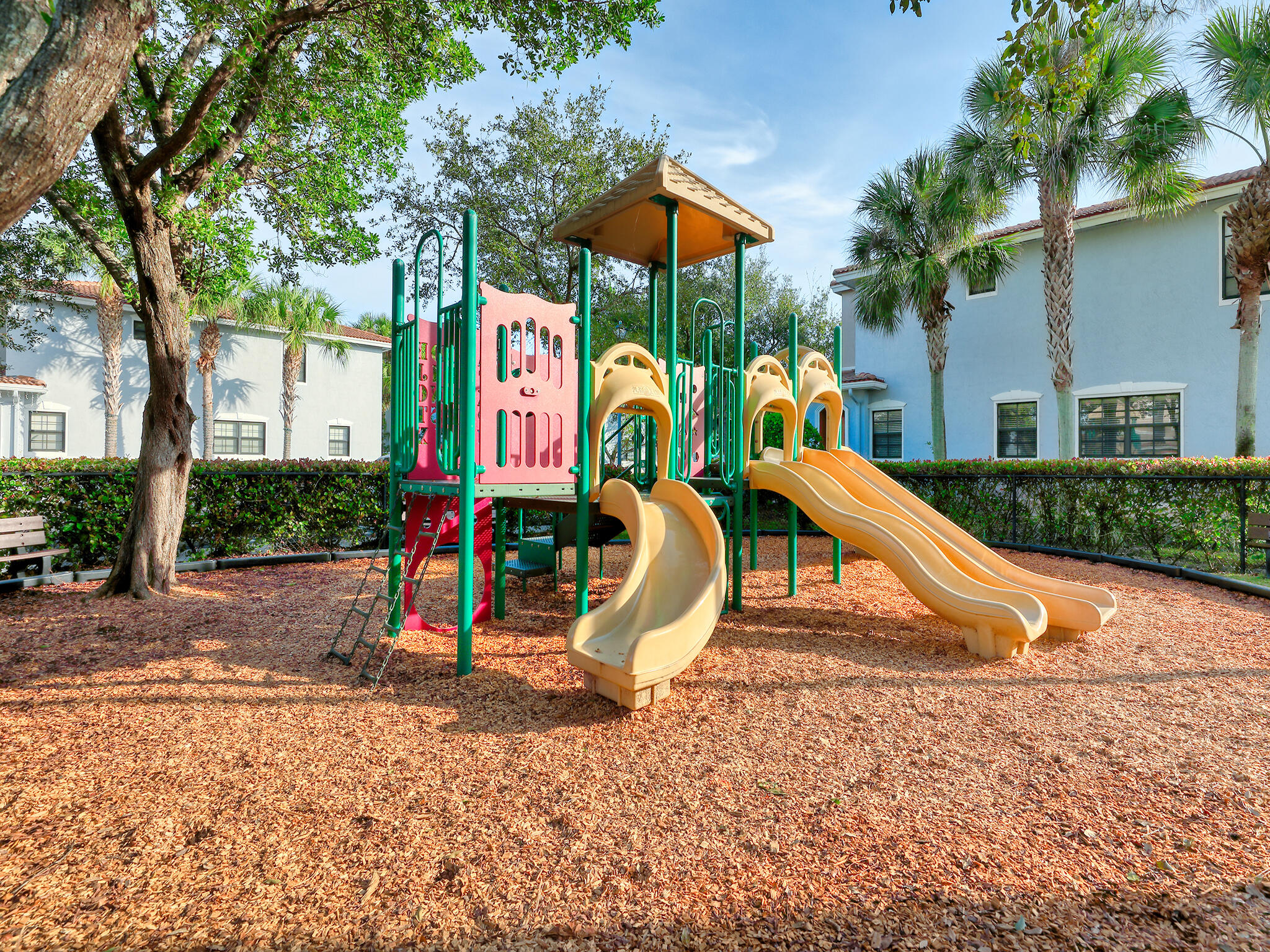 102 Astor Circle Delray Beach, FL 33484 - Photo 24 of 29 a childrens park with lots of swings and slides