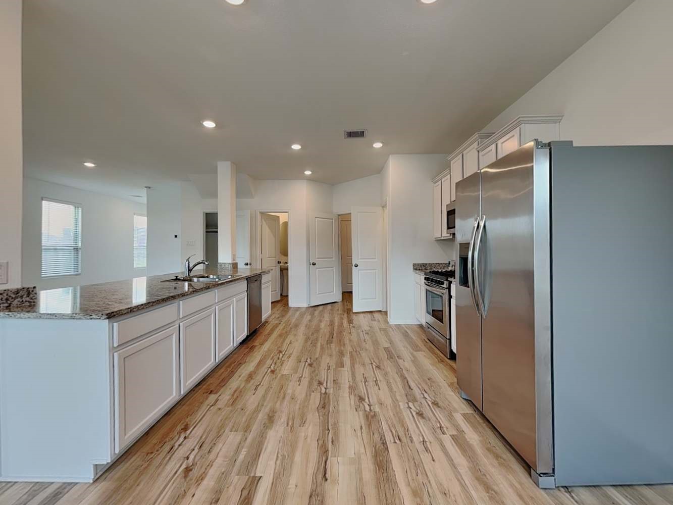 18743 Jasper Rdg Drive Hockley, TX 77447 - Photo 7 of 15 a large kitchen with a lot of counter space and wooden floor