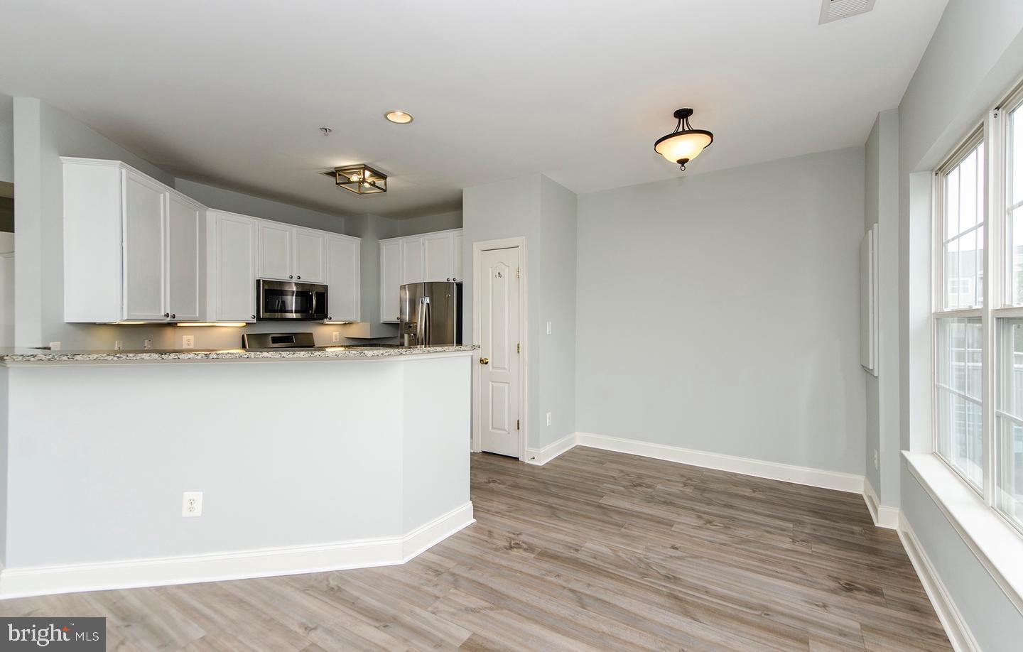 8069 Gatehouse Road, Unit 23 Falls Church, VA 22042 - Photo 18 of 43 a kitchen with stainless steel appliances a refrigerator sink and microwave
