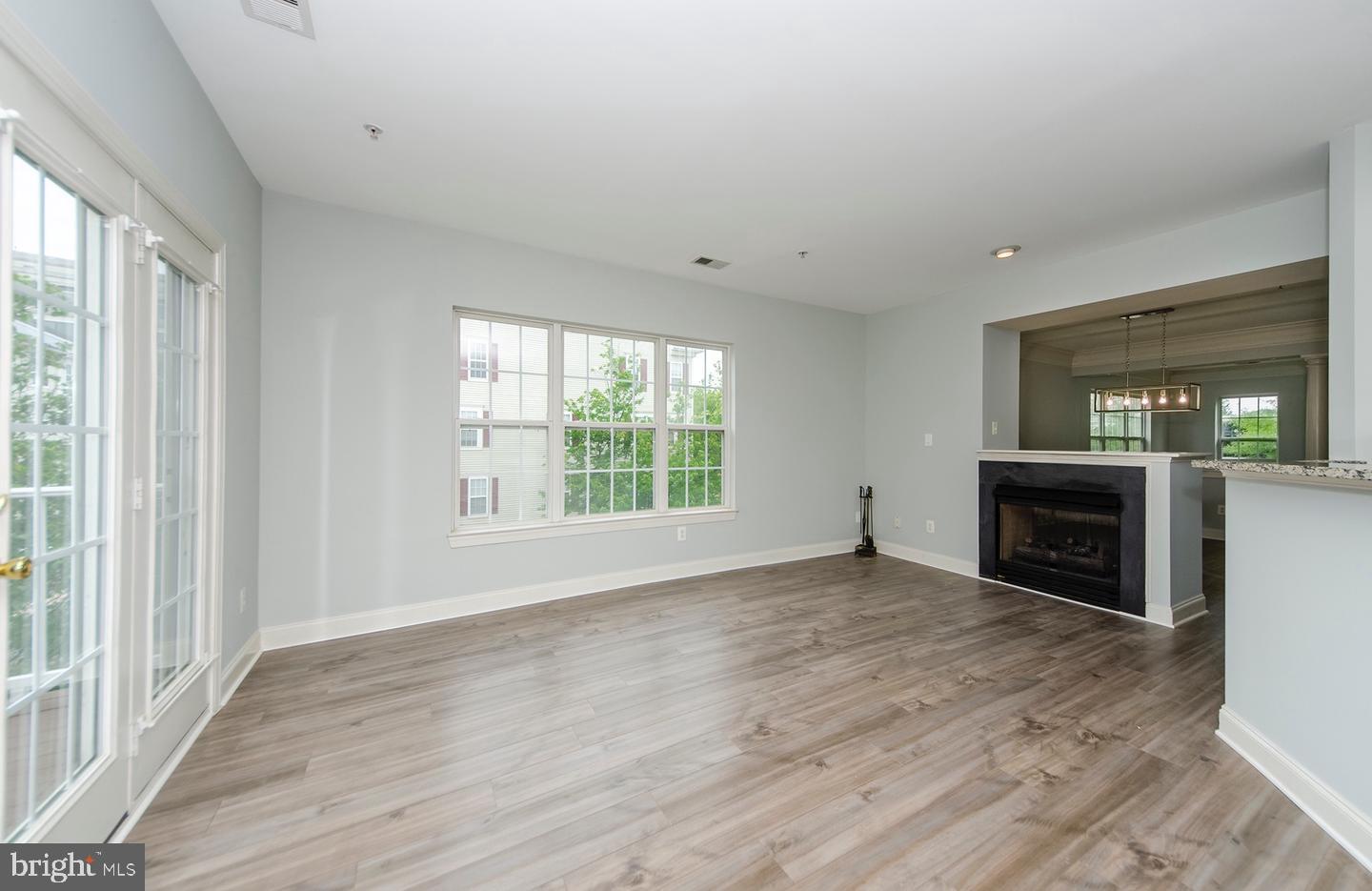 8069 Gatehouse Road, Unit 23 Falls Church, VA 22042 - Photo 19 of 43 a view of livingroom with a fireplace window and wooden floor