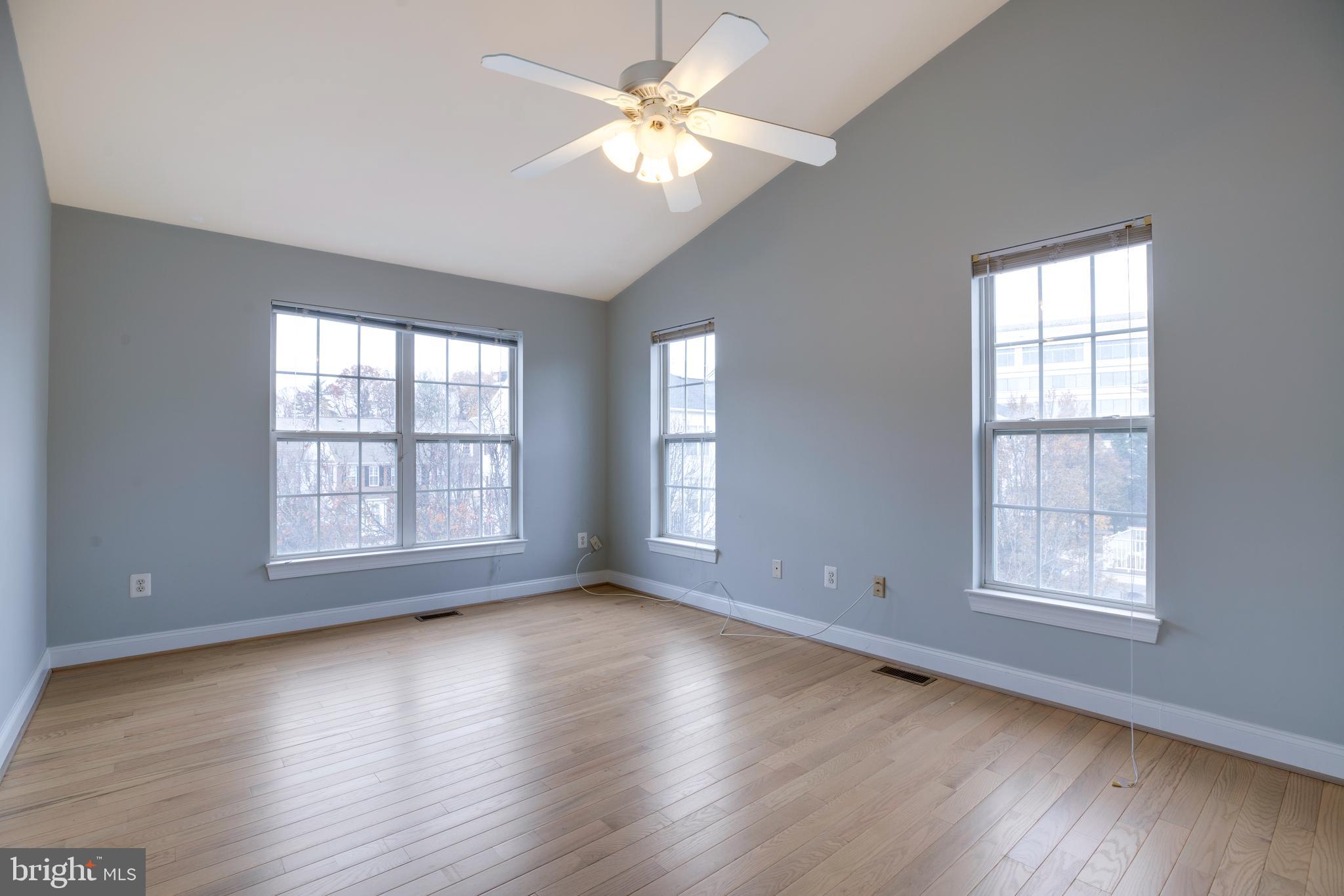 8069 Gatehouse Road, Unit 23 Falls Church, VA 22042 - Photo 22 of 43 a view of an empty room with wooden floor and a window