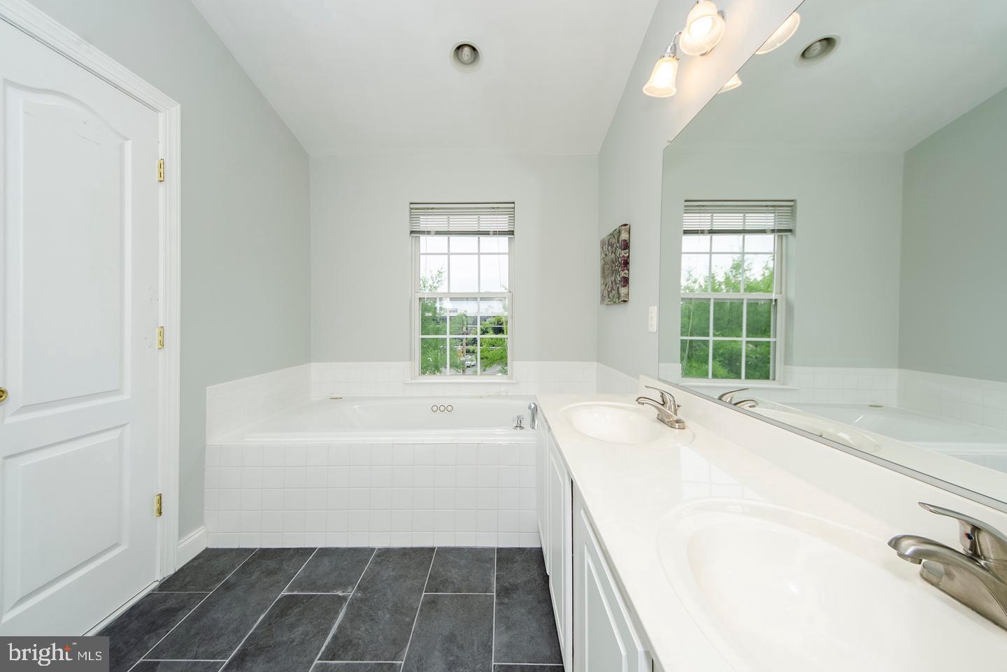 8069 Gatehouse Road, Unit 23 Falls Church, VA 22042 - Photo 24 of 43 a spacious bathroom with a tub sink and mirror