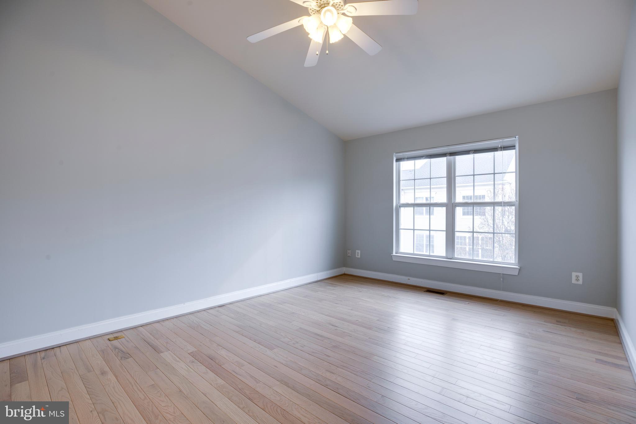 8069 Gatehouse Road, Unit 23 Falls Church, VA 22042 - Photo 30 of 43 a view of an empty room with wooden floor and a window