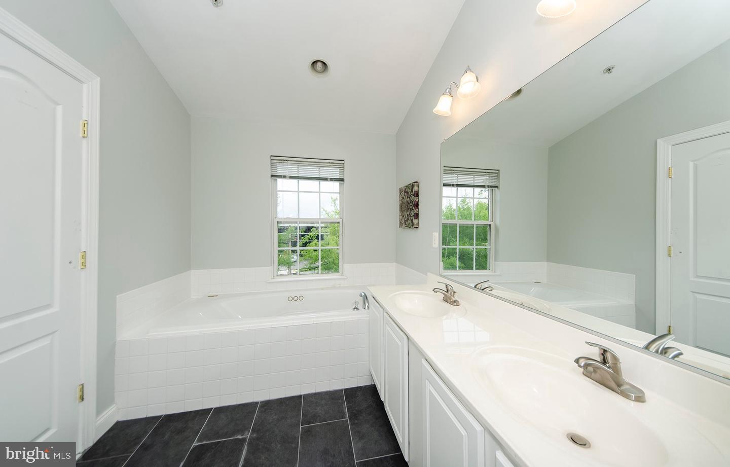 8069 Gatehouse Road, Unit 23 Falls Church, VA 22042 - Photo 31 of 43 a bathroom with a tub sink and window