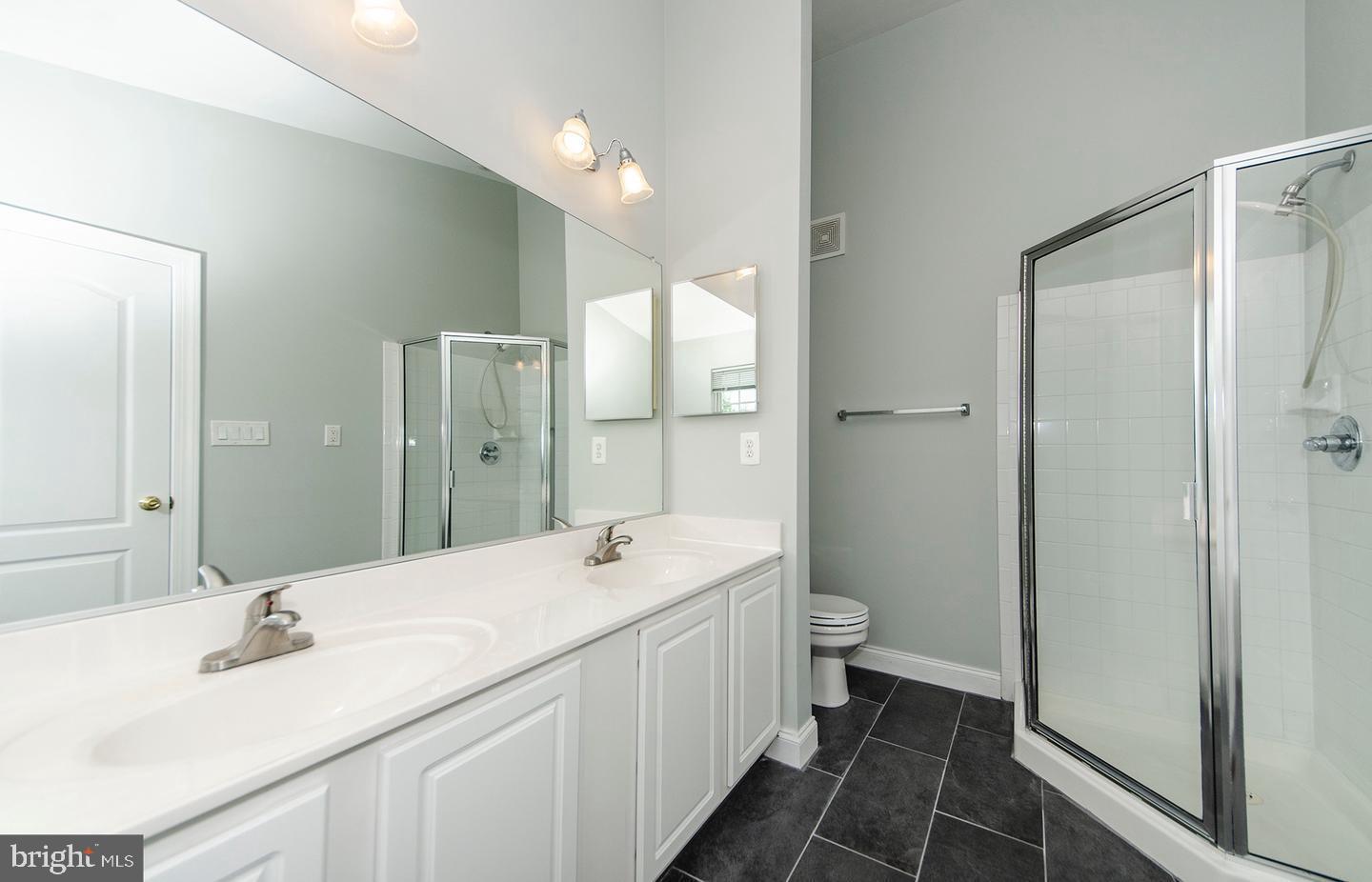 8069 Gatehouse Road, Unit 23 Falls Church, VA 22042 - Photo 32 of 43 a bathroom with a sink a toilet and shower