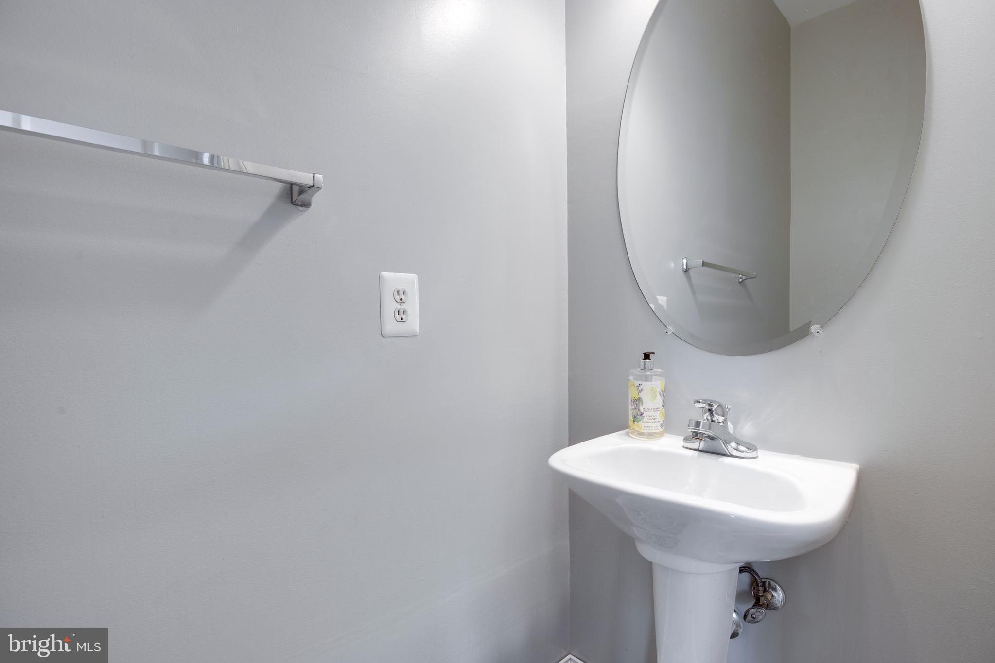 8069 Gatehouse Road, Unit 23 Falls Church, VA 22042 - Photo 37 of 43 a bathroom with a sink a mirror and vanity