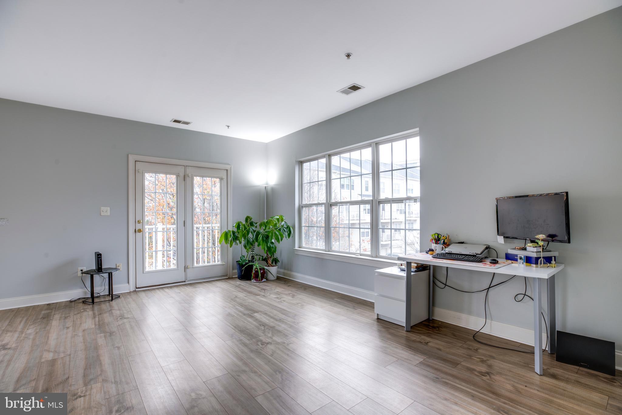 8069 Gatehouse Road, Unit 23 Falls Church, VA 22042 - Photo 4 of 43 a workspace with furniture window and wooden floor