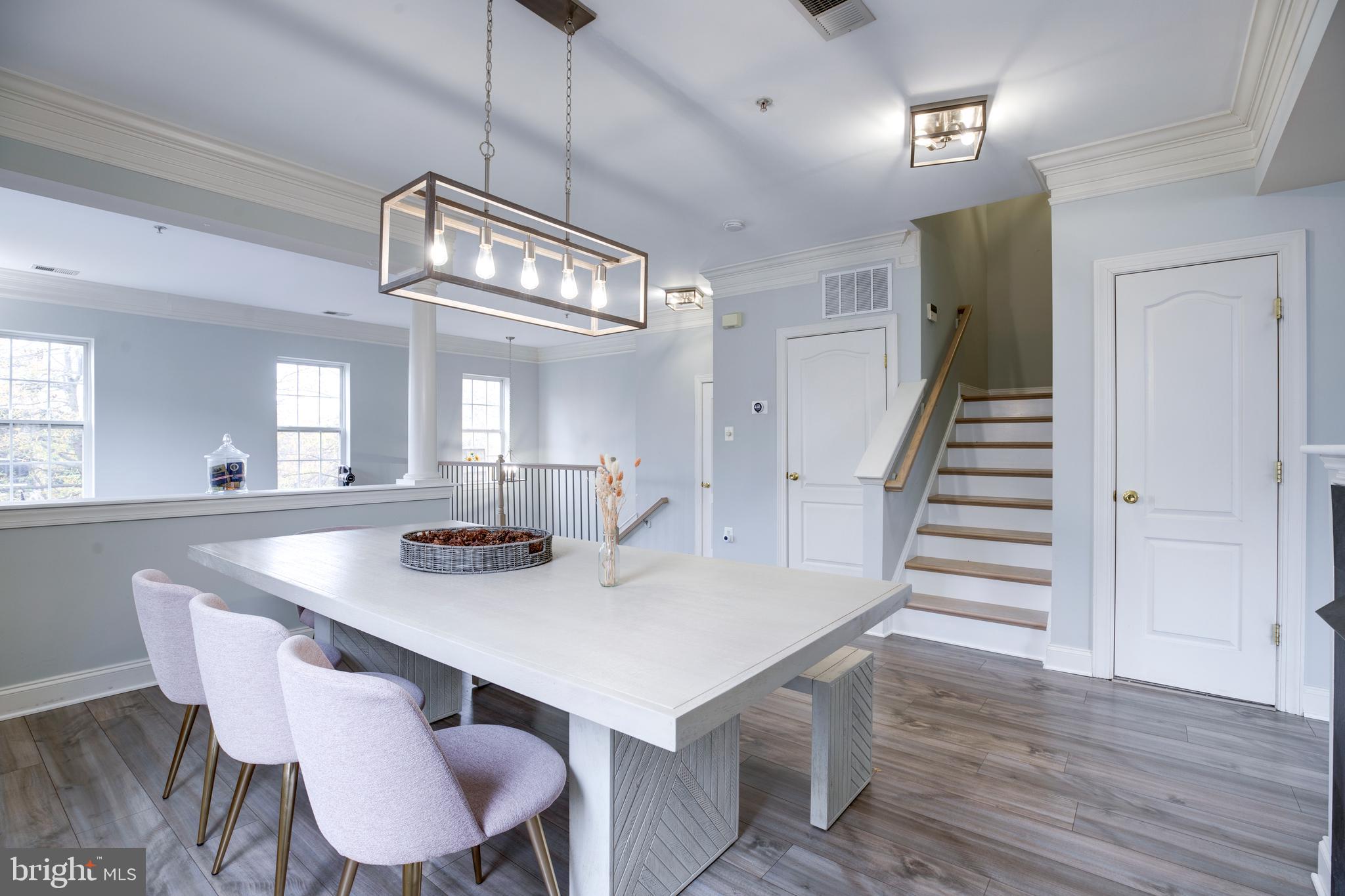 8069 Gatehouse Road, Unit 23 Falls Church, VA 22042 - Photo 6 of 43 a view of a dining room with furniture and wooden floor