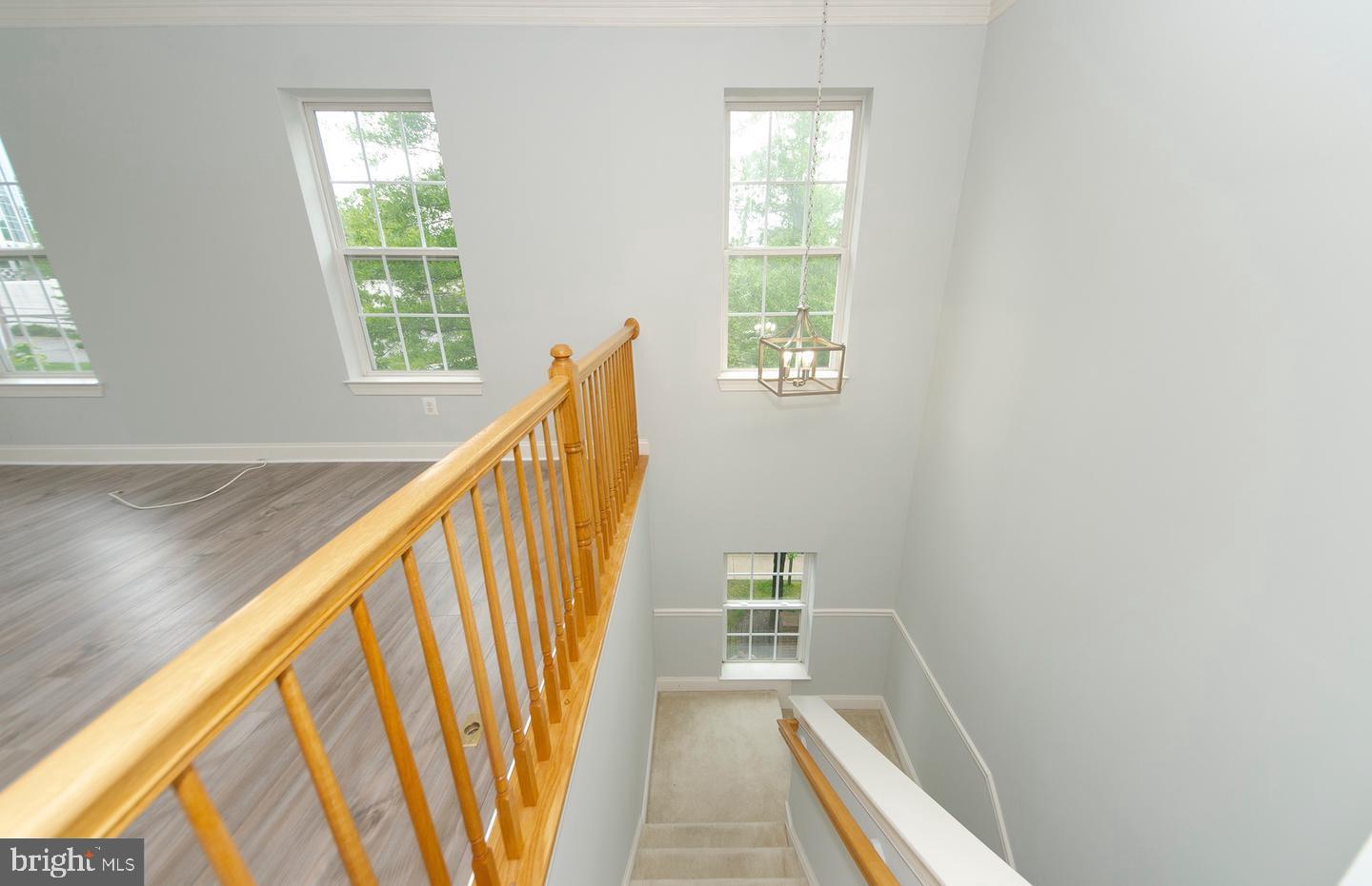 8069 Gatehouse Road, Unit 23 Falls Church, VA 22042 - Photo 10 of 43 a view of a hallway with wooden floor and staircase