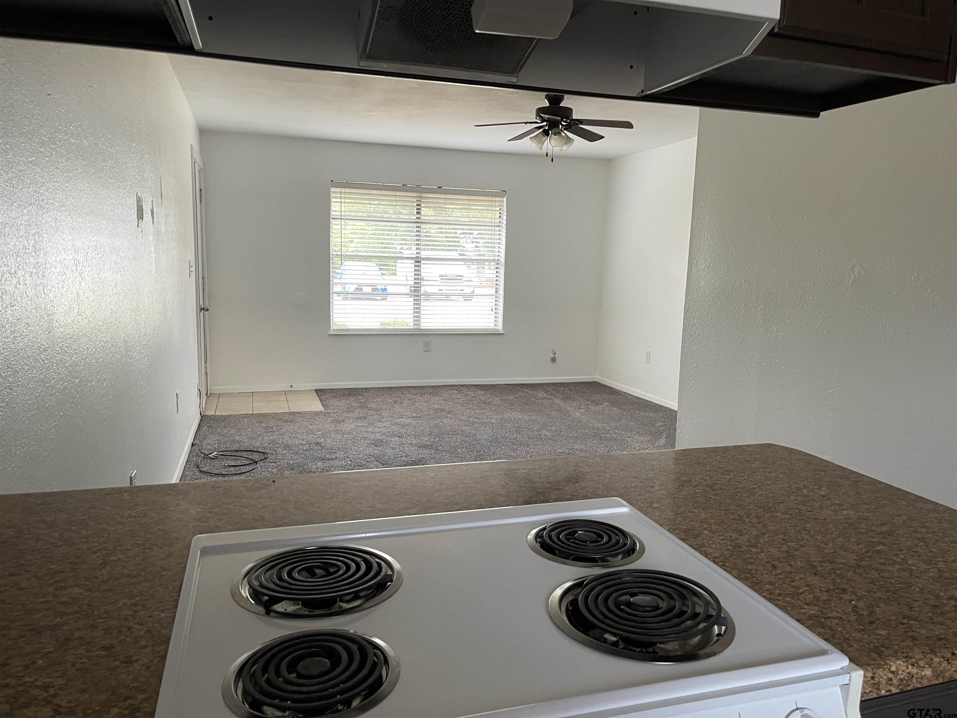 315 Circle Drive, Unit 2 Bogata, TX 75417 - Photo 2 of 11 a kitchen with a stove and a microwave