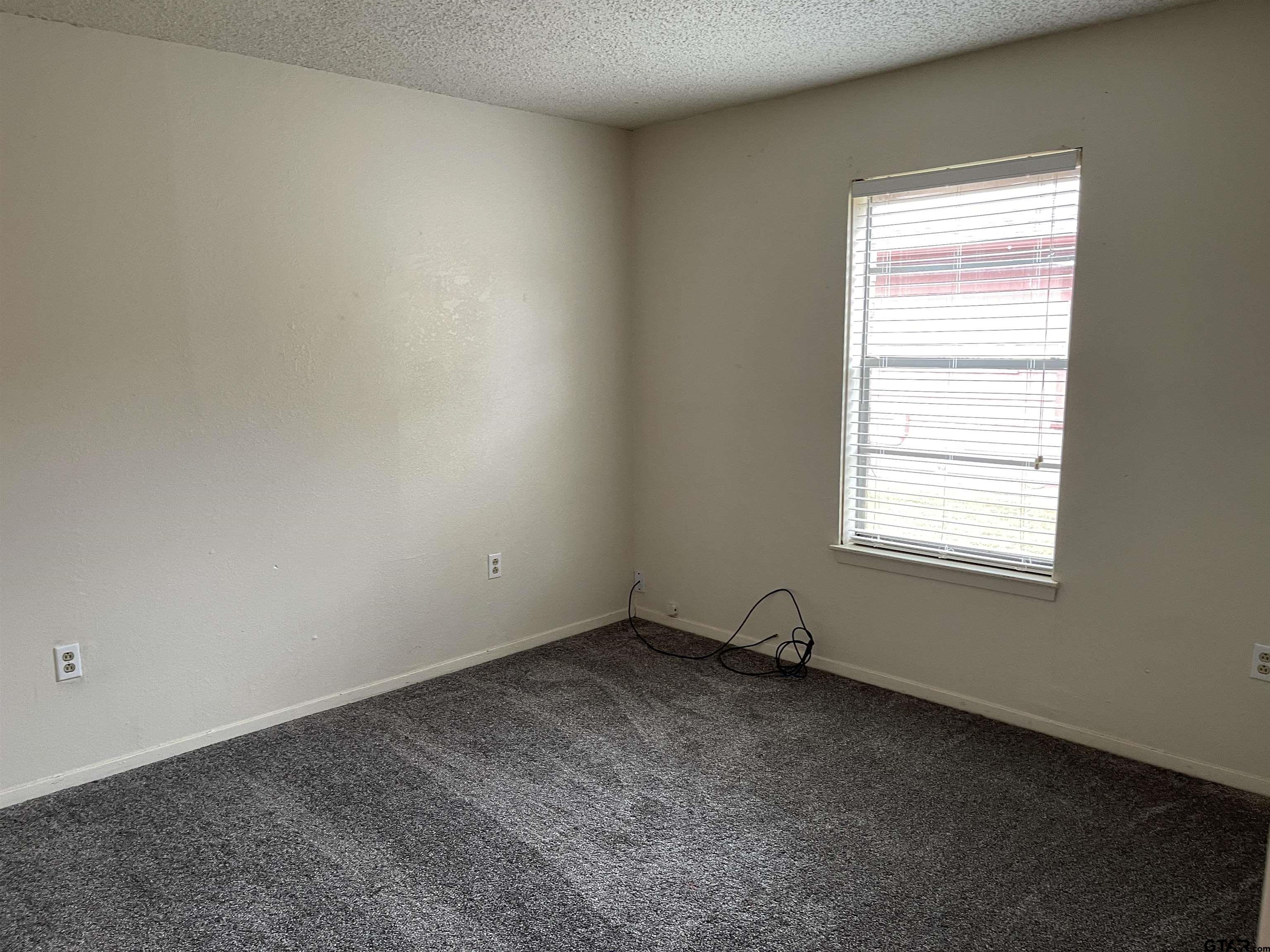 315 Circle Drive, Unit 2 Bogata, TX 75417 - Photo 6 of 11 an empty room with a window