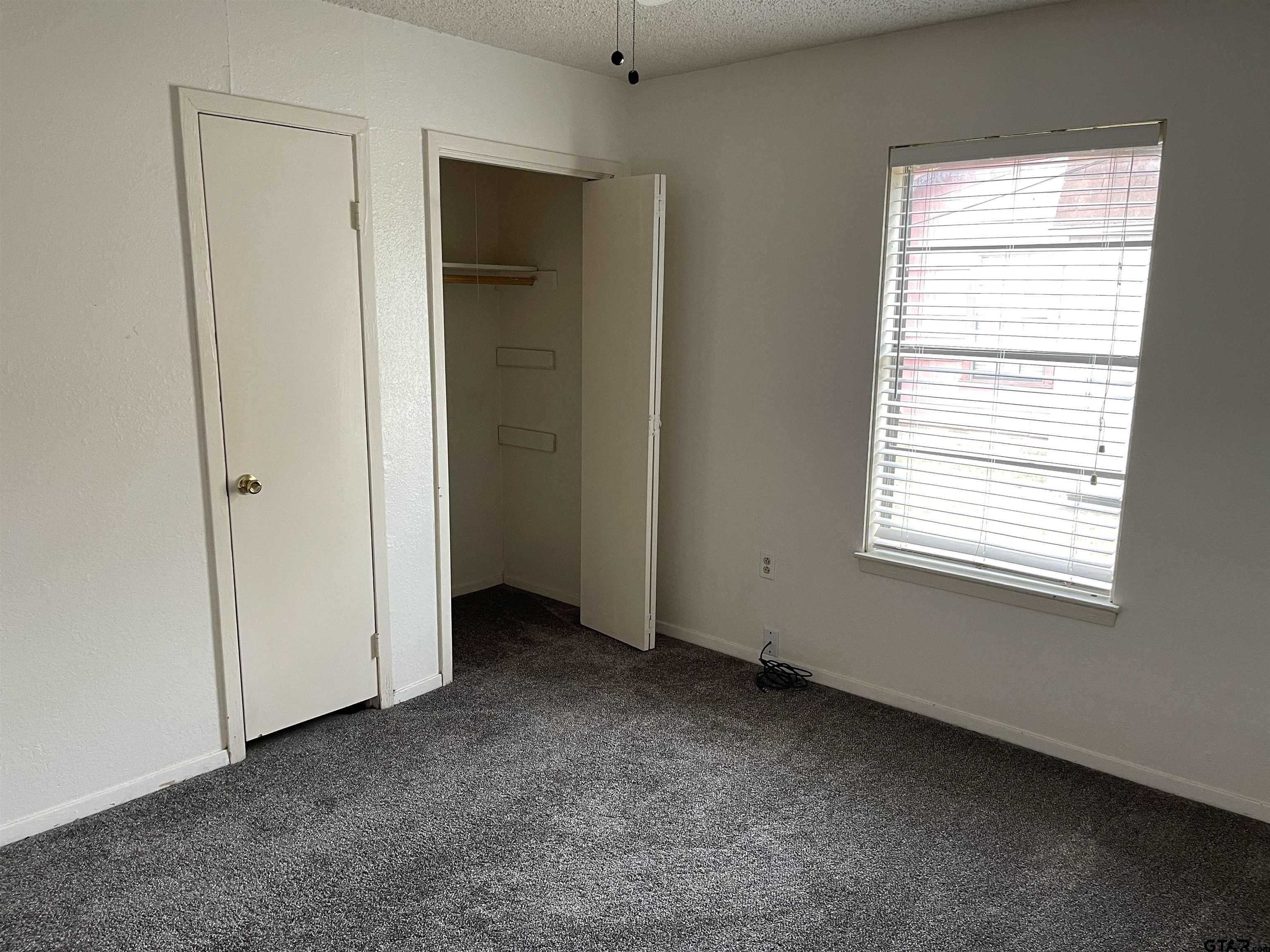 315 Circle Drive, Unit 2 Bogata, TX 75417 - Photo 7 of 11 an empty room with windows and closet