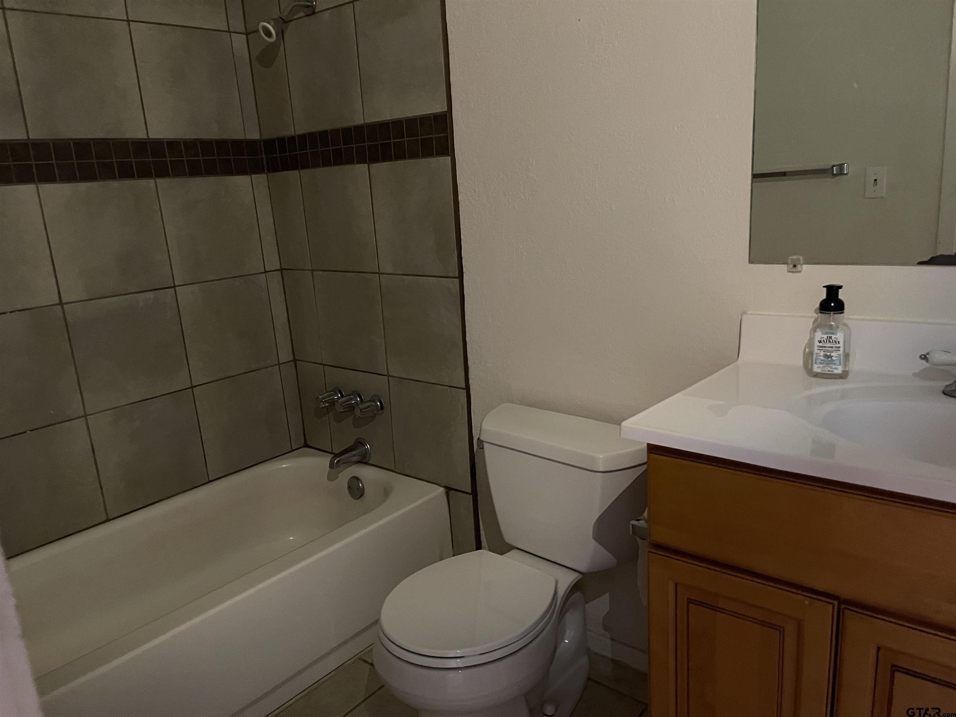 315 Circle Drive, Unit 2 Bogata, TX 75417 - Photo 8 of 11 a bathroom with a toilet a sink and bathtub
