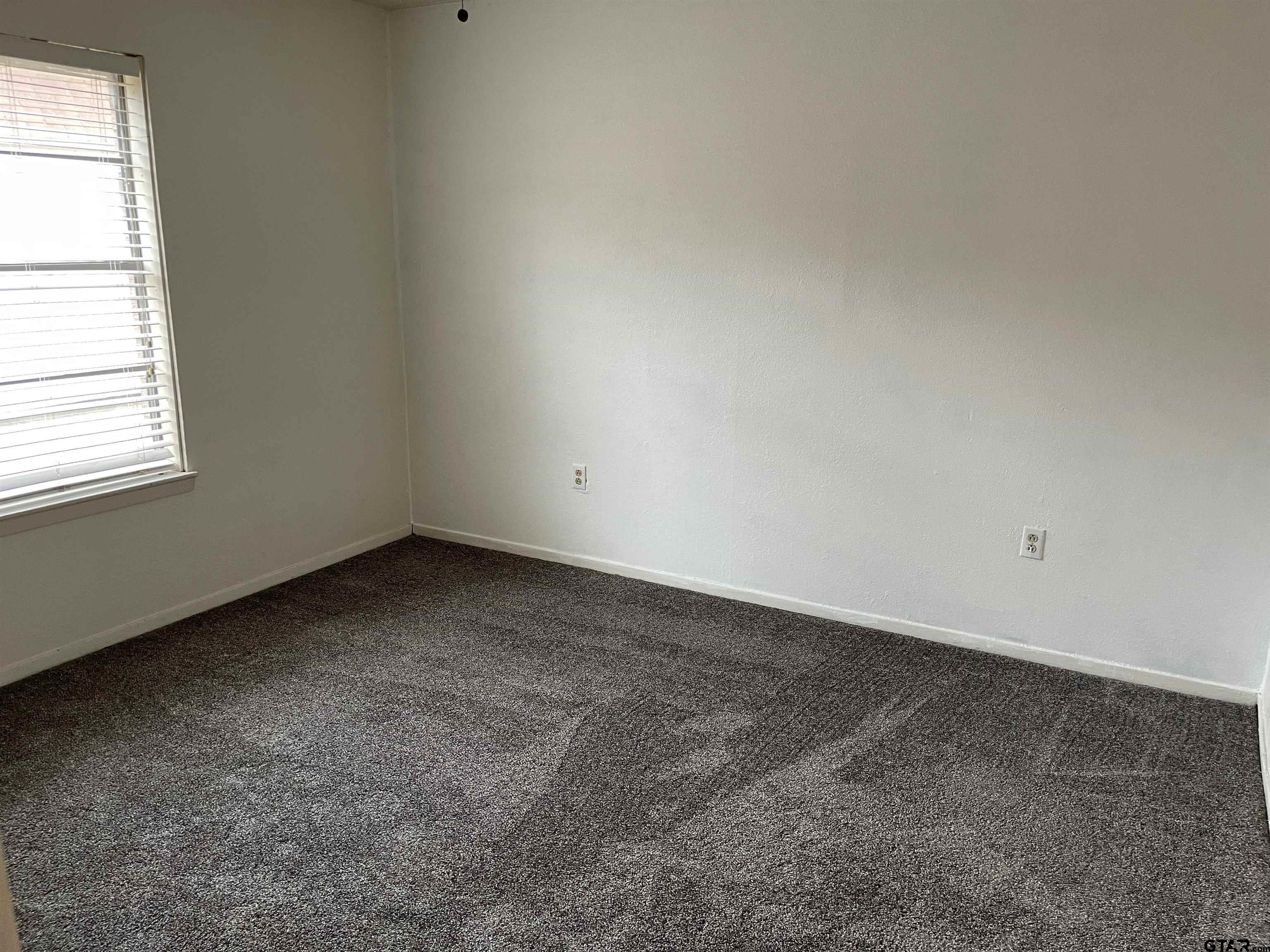 315 Circle Drive, Unit 2 Bogata, TX 75417 - Photo 9 of 11 an empty room with a window