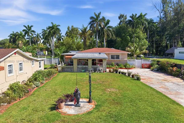 a view of a house with a yard porch and sitting area