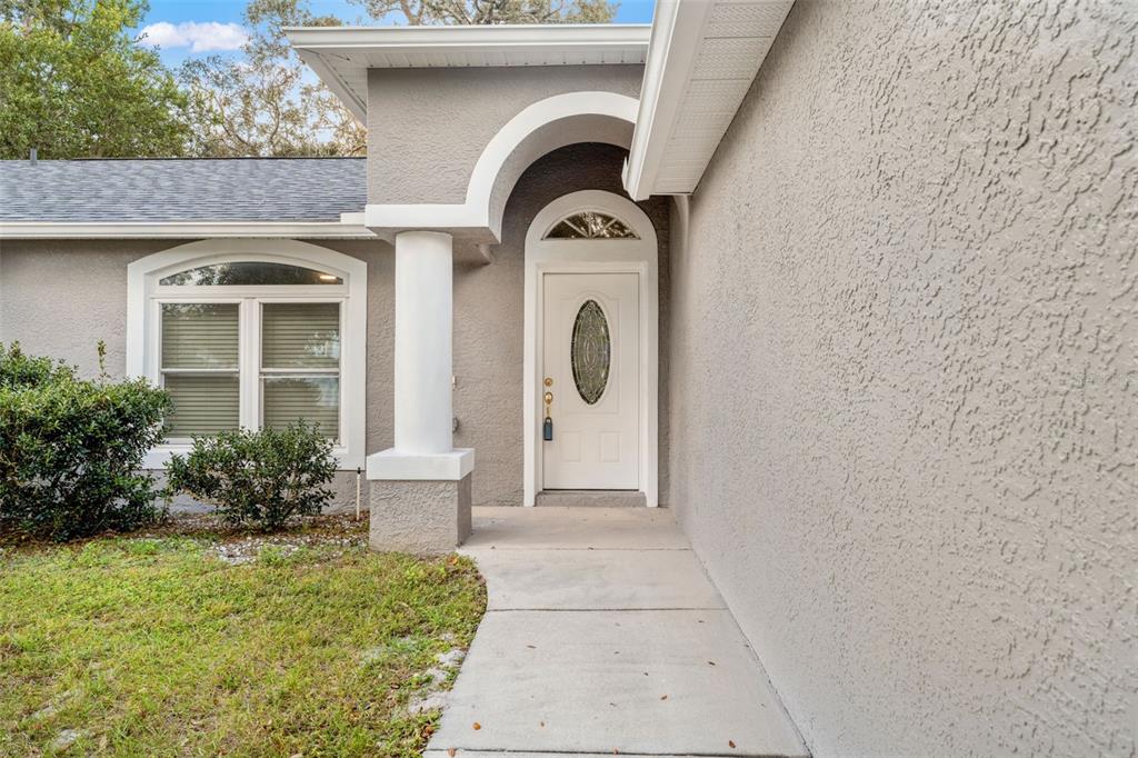 542 Fairbanks Road Spring Hill, FL 34608 - Photo 12 of 45 a front view of a house with garden
