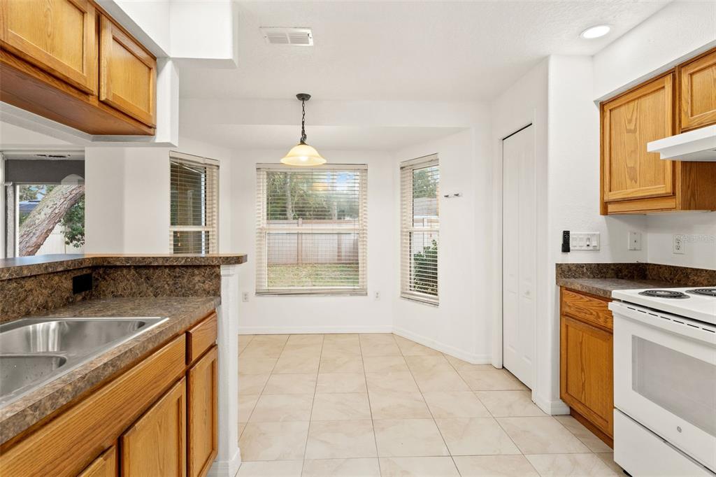 542 Fairbanks Road Spring Hill, FL 34608 - Photo 20 of 45 a kitchen with a sink stove and cabinets