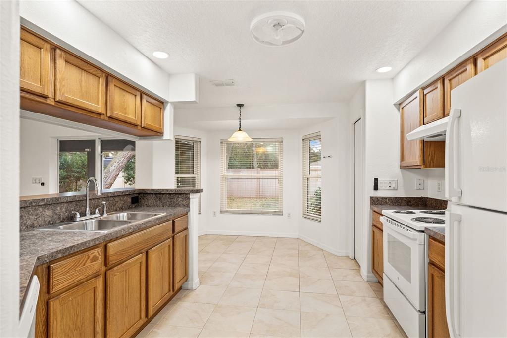 542 Fairbanks Road Spring Hill, FL 34608 - Photo 21 of 45 a large kitchen with stainless steel appliances granite countertop a stove and a sink