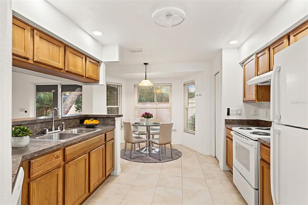 542 Fairbanks Road Spring Hill, FL 34608 - Photo 22 of 45 a kitchen with stainless steel appliances granite countertop a sink stove and refrigerator