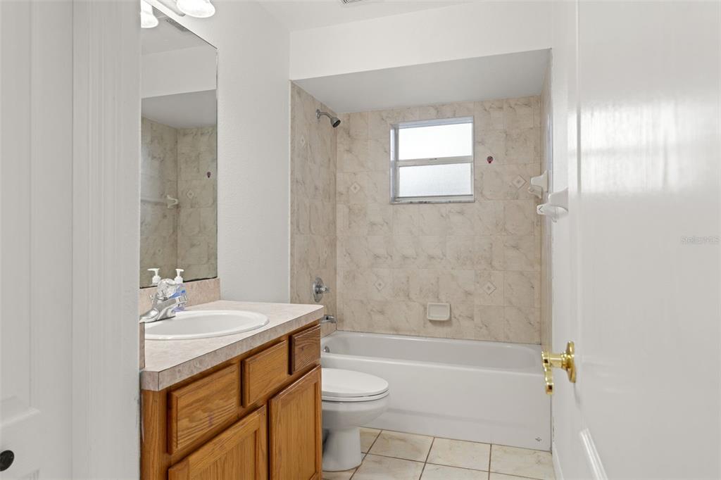 542 Fairbanks Road Spring Hill, FL 34608 - Photo 32 of 45 a bathroom with a sink a toilet and shower