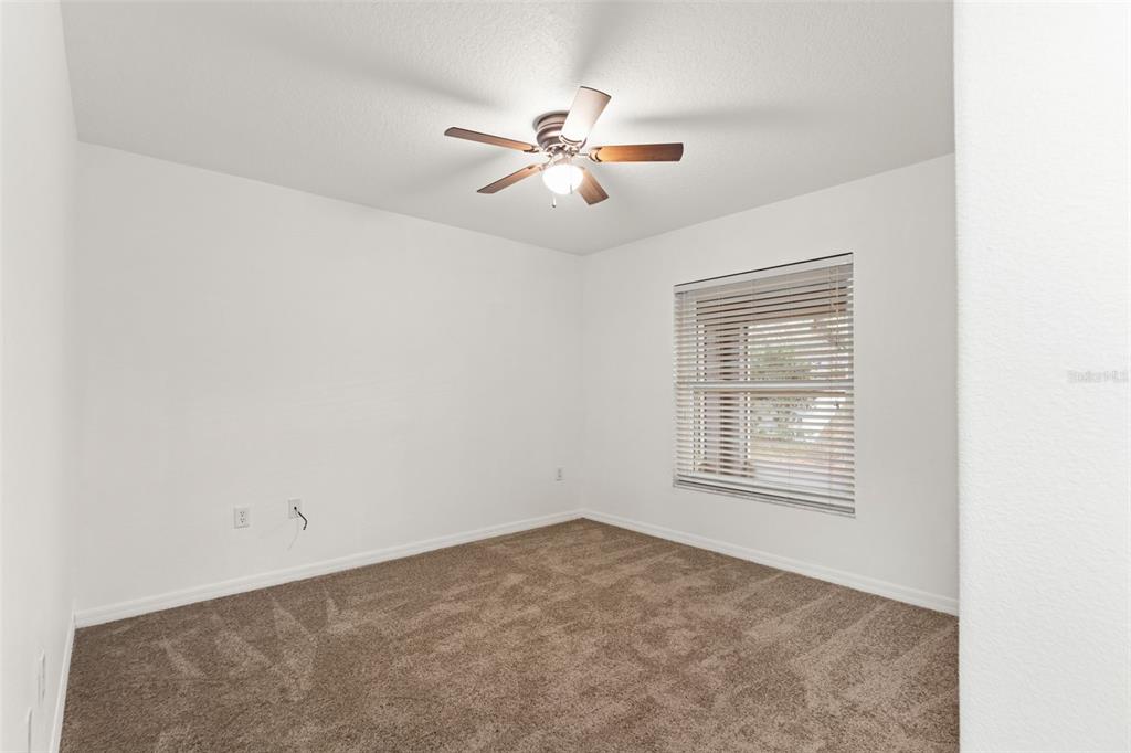 542 Fairbanks Road Spring Hill, FL 34608 - Photo 33 of 45 an empty room with windows and fan