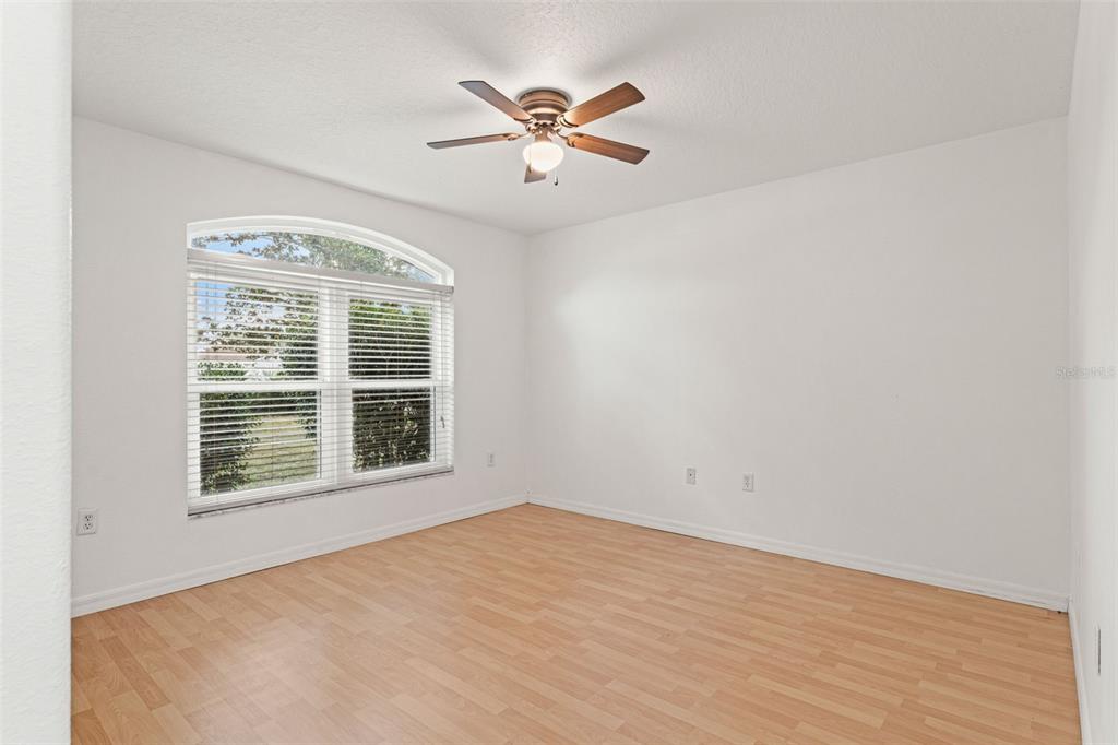 542 Fairbanks Road Spring Hill, FL 34608 - Photo 35 of 45 an empty room with wooden floor and windows