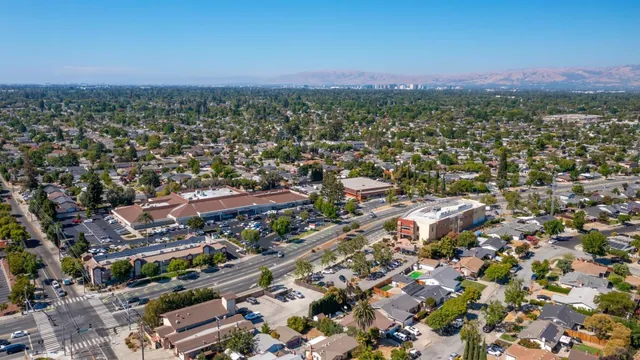 an aerial view of a houses with a yard and lake view