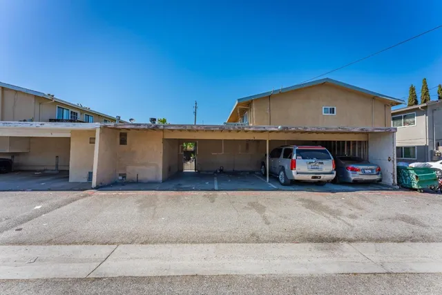 a view of a car park in front of a house