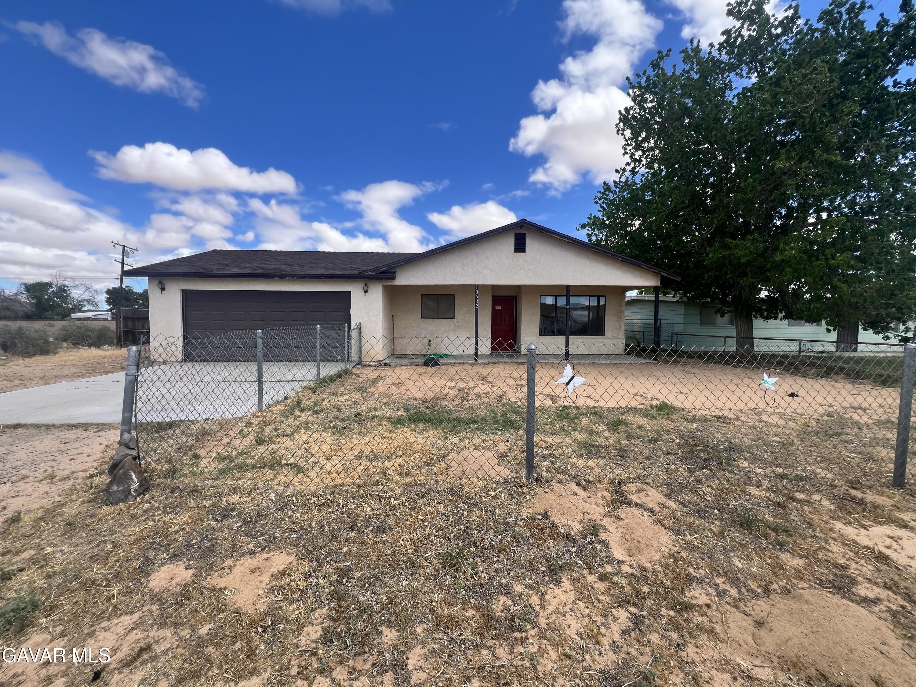 13632 Fran Street North Edwards, CA 93523 - Photo 1 of 18 a front view of a house with garden