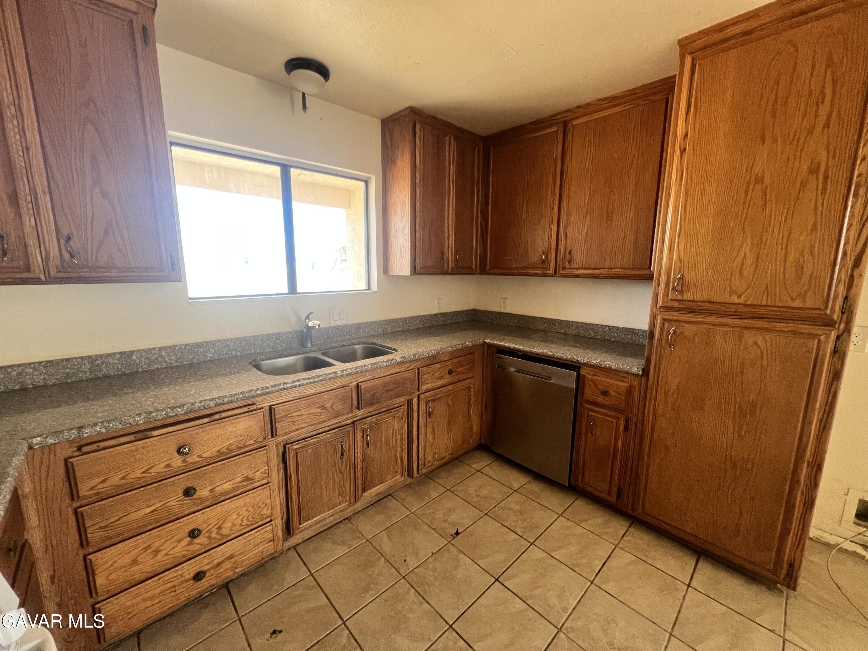 13632 Fran Street North Edwards, CA 93523 - Photo 11 of 18 a kitchen with granite countertop cabinets stainless steel appliances a sink and a window