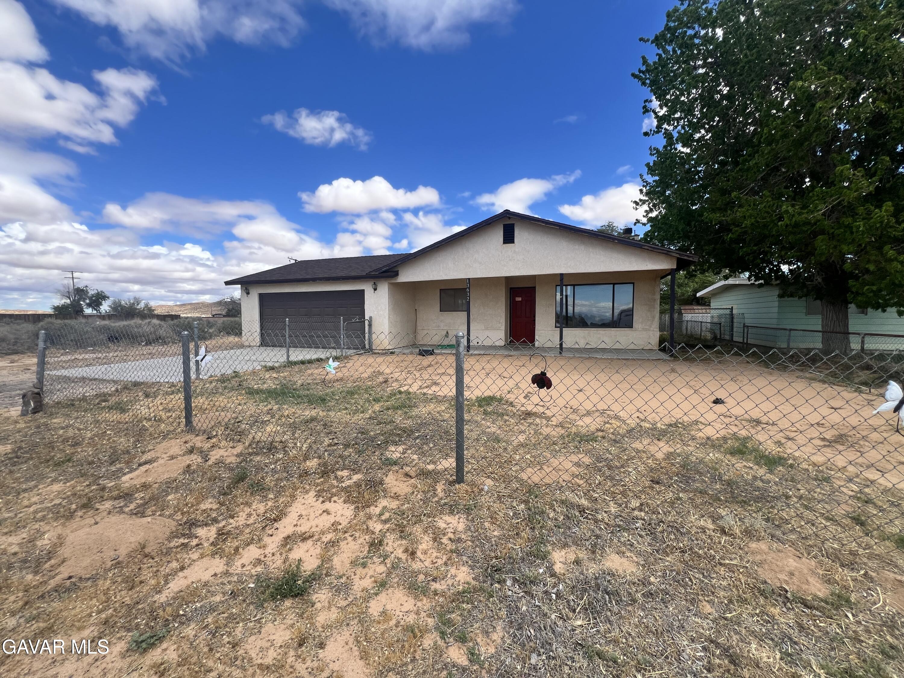 13632 Fran Street North Edwards, CA 93523 - Photo 2 of 18 a front view of a house with a yard